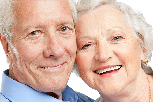 Close up of elderly couple smiling at the camera